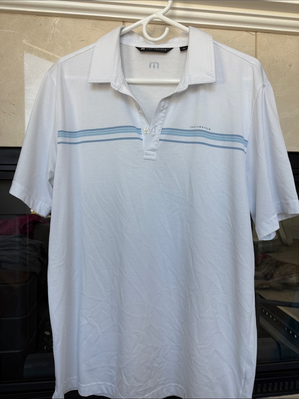 Travis Mathew White Polo with Light Blue Chest Stripes- Men’s Large